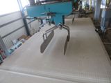 a machine that is working on a mattress in a room
