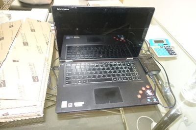 a laptop computer that is sitting on a glass table
