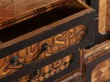 a close up of a wooden chest of drawers