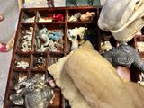 a wooden box filled with assorted items on the floor