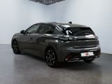 the rear end of a grey car in a white room