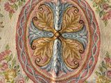 a close up of a rug with a flower design on it