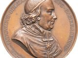 an image of a bronze medal of a man with a hat on