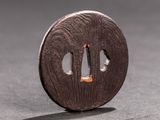 a small round metal object with a hole in it