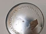 a close up of a metal object on a white surface