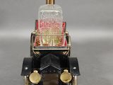 a small toy car with a bottle on top of it