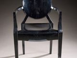 an image of a black plastic chair with a black leather seat