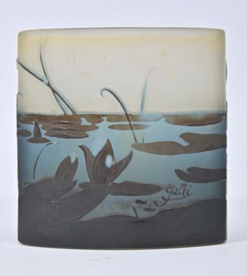 a glass vase with a picture of a pond and reeds on it