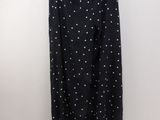 a black and white polka dot pants hanging on a hanger