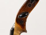 a close up of a violin neck with a fiddle in the background