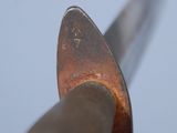 a close up of a spoon with a knife in it