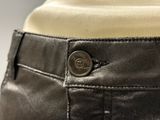 the back of a pair of black pants with a button on the side