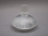 a clear glass bottle with a plastic cap on a table