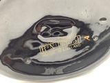 a close up of a black and white bowl with a logo on it