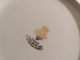 a close up of a plate with a flower on it
