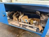 a lot of junk in the back of a blue truck