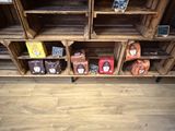 a shelf of coffee bags and coffee beans on display