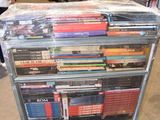 a cart full of dvds on wheels in a store