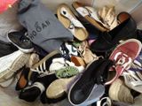 many pairs of shoes in a basket on the floor