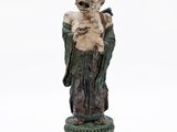 an old statue of a man holding a bird on a pedestal