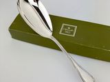 a silver spoon sitting on top of a green box
