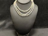 a close up of a necklace on a mannequin display