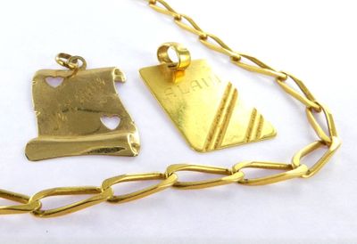 a gold necklace with a piece of jewelry on it