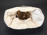a bag with a hat inside of it on a black surface