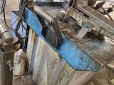 an image of a machine that is working on a piece of metal