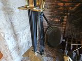 a fireplace with a bunch of brass items on it