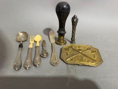 a lot of silverware on a table with a spoon, fork and knife holder