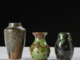 three vases sitting next to each other on a table