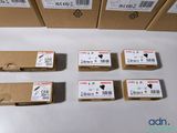 several boxes of different sizes and colors of electronic equipment on a table