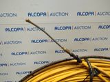 a close up of a yellow hose with a stick on top of it