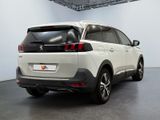 the rear end of a white suv parked in a garage
