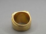 a close up of a gold ring on a table