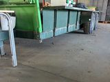 an image of a green dump truck parked in a warehouse