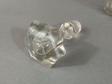 a clear glass bottle with a clear cap sitting on a table