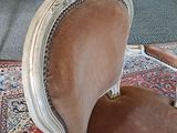 a chair that is sitting on a rug in a room
