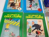 several children ' s books are lined up on a table