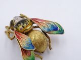 a gold and enamel insect brooch with multicolored wings