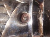 a close up of a piece of metal with a bolt