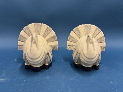 pair of white ceramic turkey figurines on black bases
