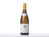 a bottle of white wine sitting on top of a table