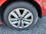 a close up of a tire on a red car