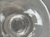 a glass with a liquid inside of it sitting on a table