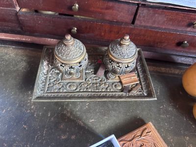 a small tray with two jars on it next to a book