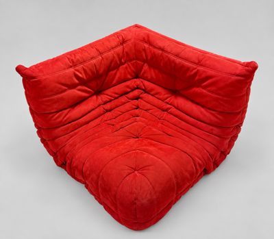a red futon chair on a white background