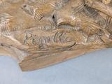 a bronze statue of a dog with a bowl on it