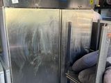 an image of a refrigerator in a garage with a lot of stuff